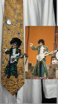 Gold Paisley Prince Pointing With White Guitar Performing Purple Rain at the AMA 1985 Tie