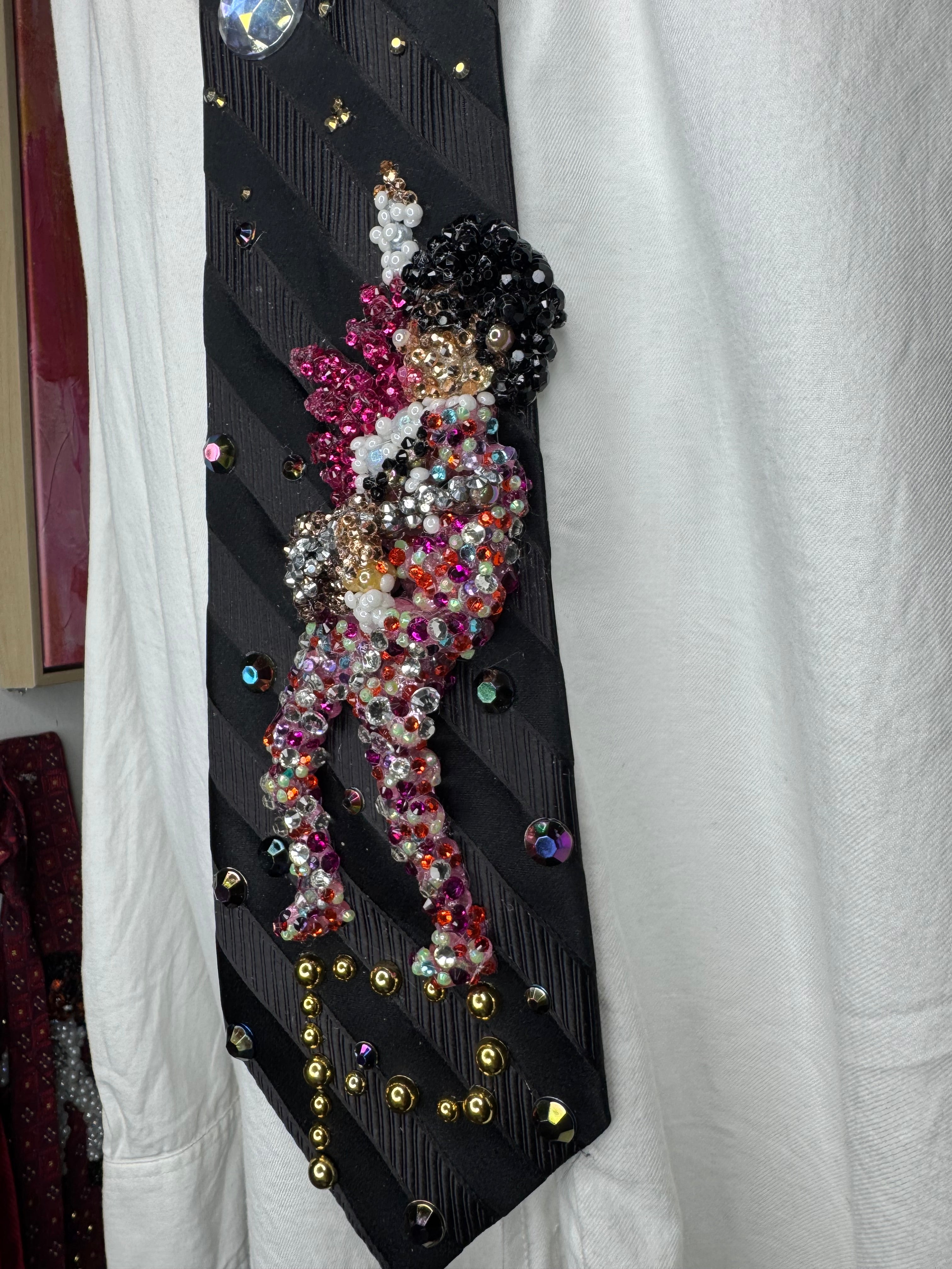 Black Striped Prince Rocking Out in Color Spotted Outfit with Pink Scarf Performing Tie