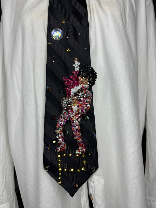 Black Striped Prince Rocking Out in Color Spotted Outfit with Pink Scarf Performing Tie