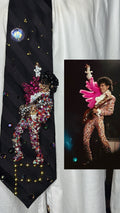 Black Striped Prince Rocking Out in Color Spotted Outfit with Pink Scarf Performing Tie