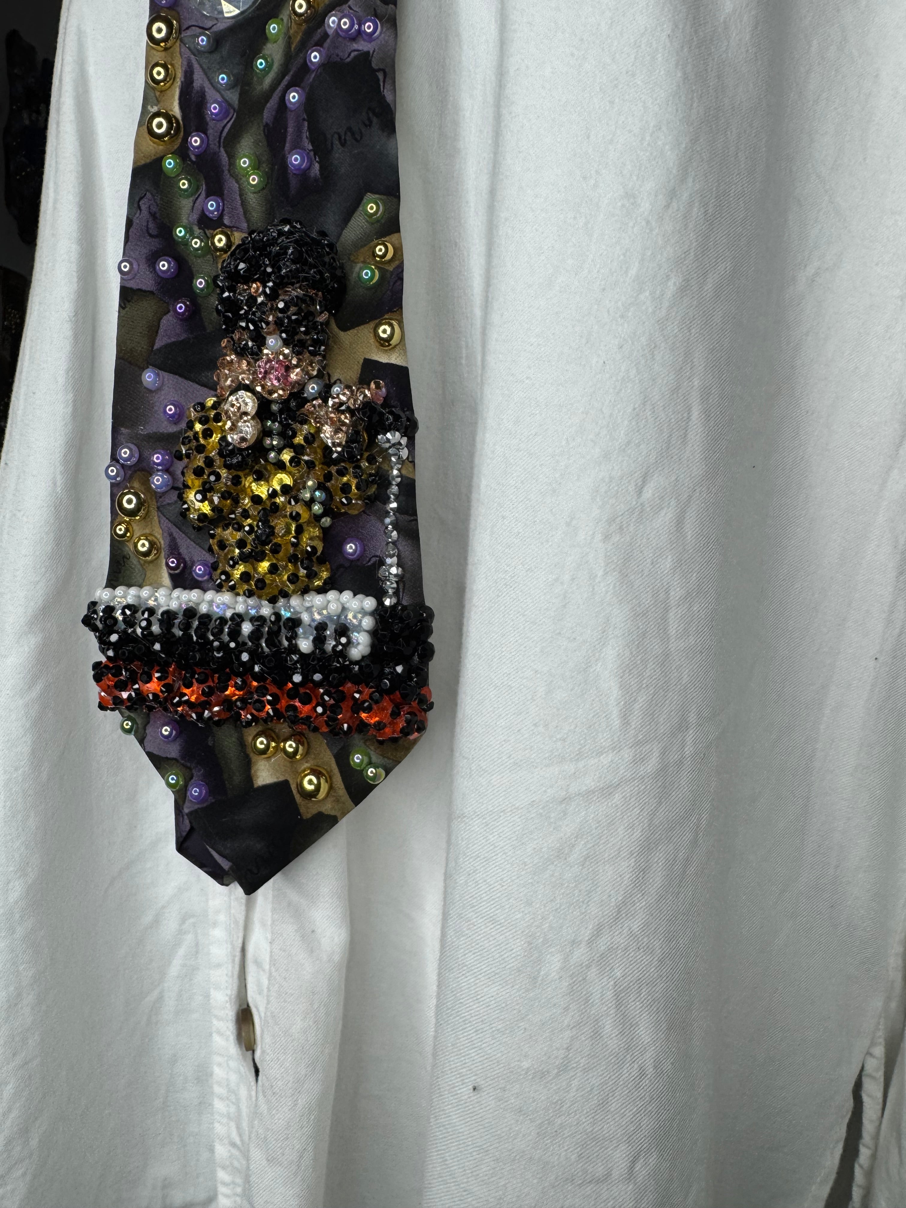 Purple Gold, and Green Marbled Prince in Full Yellow Polka Dot Suit Playing on Orange Cheetah Print Piano Live Tie